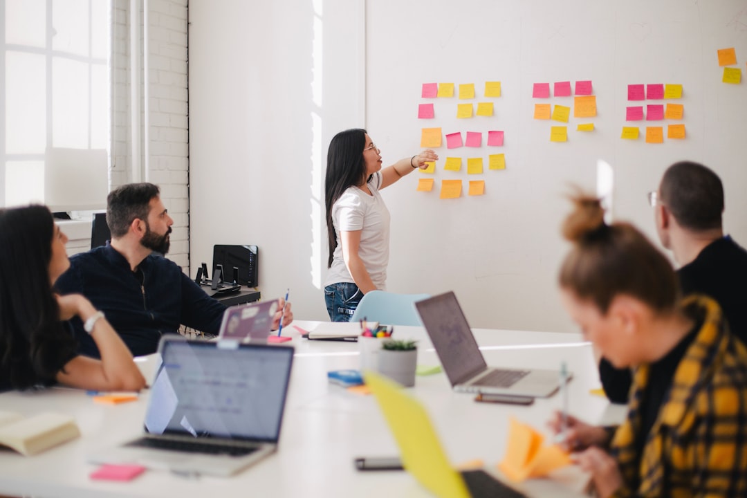 woman-placing-sticky-notes-on-wall-oalh2mojuuk